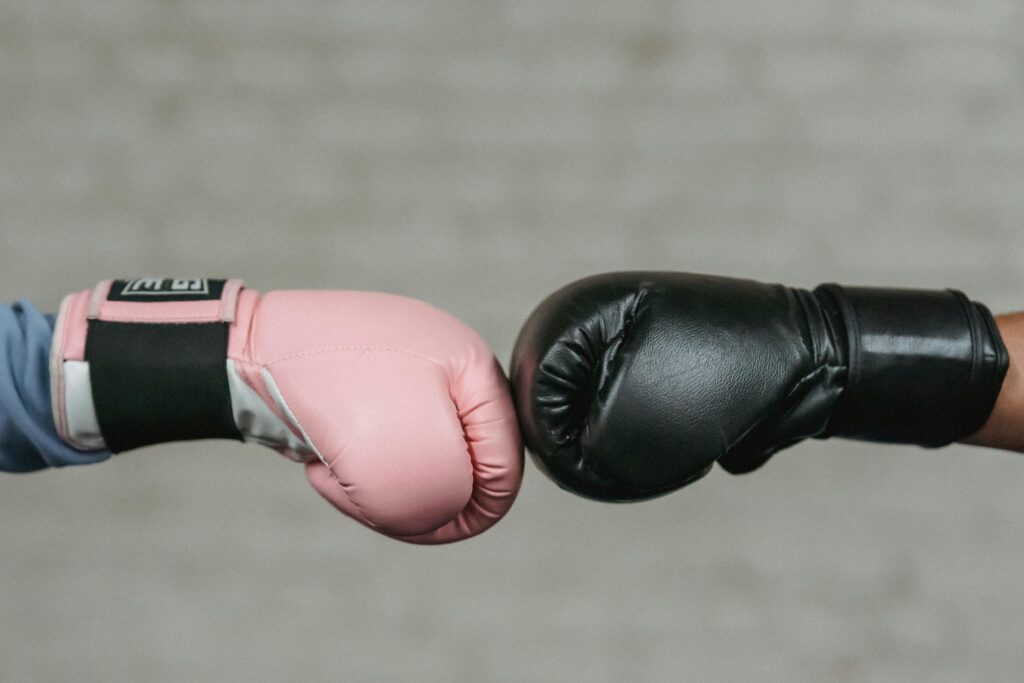 pexels-photo-6456264-6456264 Sid view of crop unrecognizable boxers in protective gloves bumping fists before fight in ring